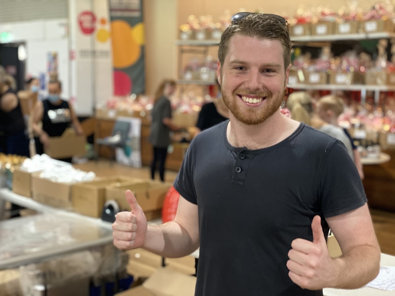 Red Frogs' Justin gives Addi Road's Hampers of Hope the thumbs up.