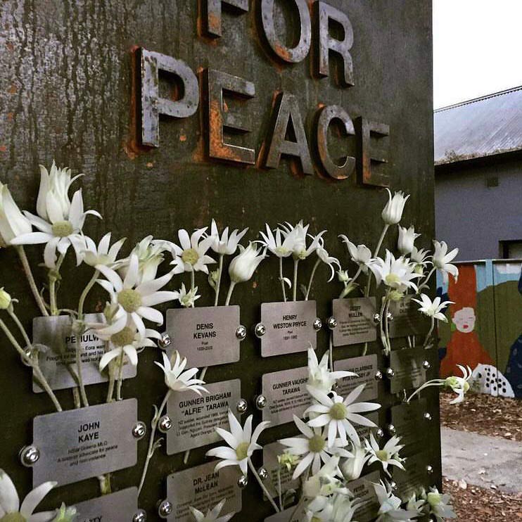 Metal plaques with names with flannel flowers amongst them