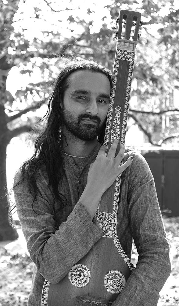 Bearded man holding a sitar